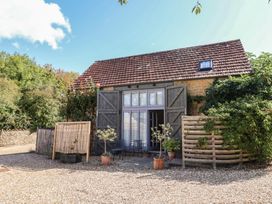 An exterior view of a house with garden features at The Stone Barn in Bridport