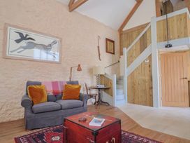 A living room with a sofa and coffee table at The Stone Barn in Bridport