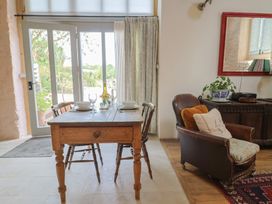 A dining room with a table and chairs at The Stone Barn in Bridport