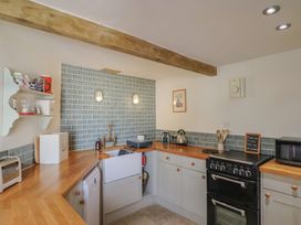 A kitchen with appliances and a wood countertop at The Stone Barn Bridport