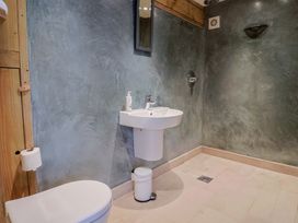 A bathroom with a toilet and sink at The Stone Barn in Bridport