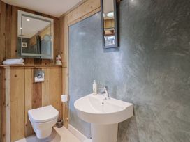 A bathroom with a toilet and sink at The Stone Barn in Bridport