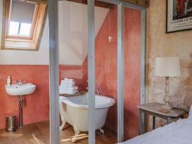 A bathroom with a bathtub and sink at The Stone Barn in Bridport