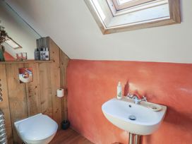 A bathroom with toilet and sink at The Stone Barn in Bridport