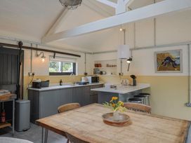 A kitchen with a table and chairs at The Dairy in Bridport