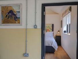 A bedroom with a bed and lamps at The Dairy in Bridport