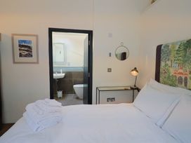 A bedroom with a bed and an en suite bathroom at The Dairy in Bridport