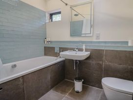 A bathroom with a bathtub, sink, and toilet at The Dairy in Bridport