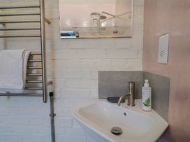 A bathroom with a sink and towel rack at The Dairy Bridport