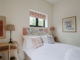 A bedroom with a bed and lamp at The Dairy in Bridport