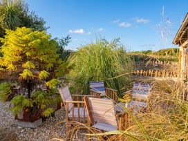 An outdoor seating area with plants and chairs at The Dairy in Bridport