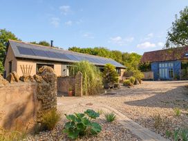 An outdoor area with a building and gravel at The Dairy in Bridport