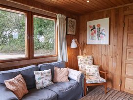 A snug with a sofa and armchair at 10 Pinewood Retreat in Pinewood