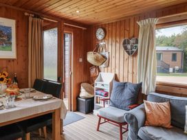A living room with a dining table and chairs at 10 Pinewood Retreat in Pinewood