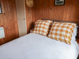 A bedroom with a bed and checked pillows at 10 Pinewood Retreat in Pinewood