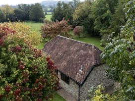 A building surrounded by trees and grass at The Cider House in Dalwood