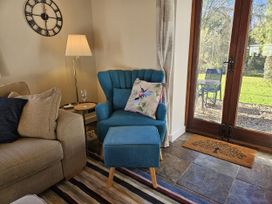 A living room with furniture including a chair and couch at The Cider House in Dalwood