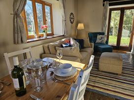 A living room with a sofa and dining table at The Cider House in Dalwood