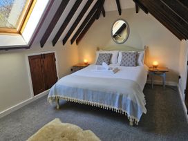 A bedroom with a bed and nightstands at The Cider House in Dalwood