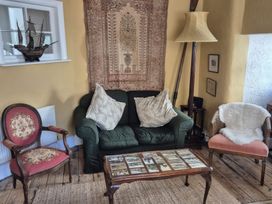 A living room with a sofa and coffee table at Old Monmouth in Lyme Regis
