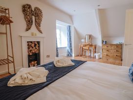 A bedroom with a bed and dresser at The Little Rose in Lyme Regis