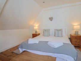 A bedroom with a bed and nightstands at The Little Rose in Lyme Regis