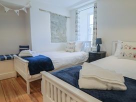 A bedroom with two beds and a window at The Little Rose in Lyme Regis