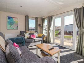 A living room with a sofa and coffee table at Away Daze in Carnaby near Bridlington