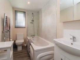 A bathroom with a bath tub and a toilet at Away Daze in Carnaby near Bridlington