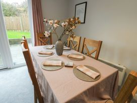 A dining room with a table set for a meal at 11 Parc Delfryn Brynteg near Benllech