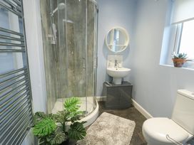 A bathroom with a shower and toilet at 11 Parc Delfryn Brynteg near Benllech