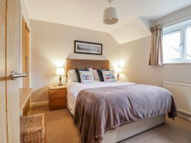 A bedroom with a double bed and bedside furniture at Green Cottage in Borth-Y-Gest