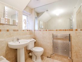 A bathroom with a sink and a toilet at Green Cottage in Borth-Y-Gest