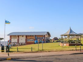 A seaside park area with a pavilion a building with a curved roof and a seaside award flag at Flat 1 in Hunstanton