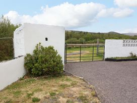 An outdoor area with a gate and white wall at Forest View, Ballinskelligs, County Kerry