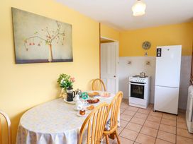A kitchen with a table and chairs at Forest View in Ballinskelligs, County Kerry