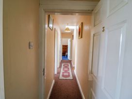 A hallway with doors and a carpet at Forest View in Ballinskelligs, County Kerry