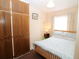 A bedroom with a bed and wardrobe at Forest View in Ballinskelligs, County Kerry
