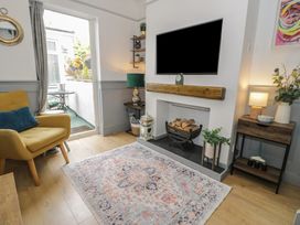 A living room with a television and a rug at 4 Haven Villas in Conwy