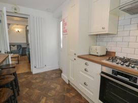 A kitchen with a toaster and cooker at 4 Haven Villas in Conwy