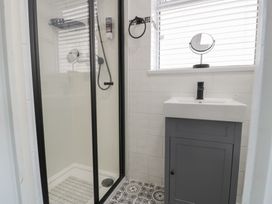 A bathroom with a shower and sink at 4 Haven Villas in Conwy