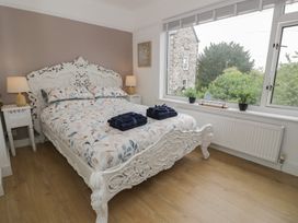 A bedroom with a bed, bedside table, and towels at 4 Haven Villas in Conwy