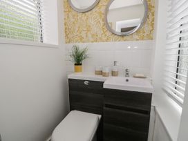 A bathroom with a toilet and sink at 4 Haven Villas in Conwy