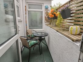 A balcony with a table and chairs at 4 Haven Villas in Conwy