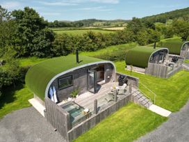 Cabins with grass roofs and outdoor seating area at Low Longlands in Cartmel