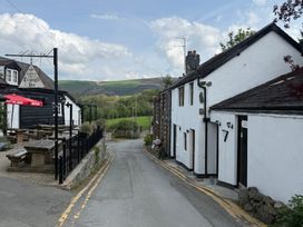 An outdoor view of Triangle Inn and surrounding scenery in Rhayader