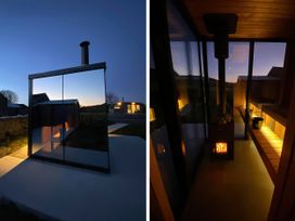 An outdoor area featuring a glass structure and a fireplace at Middle Longlands in Cartmel