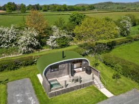 A garden with a modern shed and outdoor seating area at Little Heaning in Cartmel