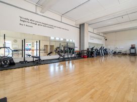 A gym with weights and exercise machines at Harcombe House Accessible Pet Free Bungalow Sleeps 5 in Chudleigh