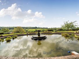 A garden with a fountain and pond at Harcombe House Accessible Pet Free Bungalow Sleeps 5 Chudleigh